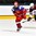 GRAND FORKS, NORTH DAKOTA - APRIL 18: Russia's Pavel Dyomin #8 and Latvia's Olafs Berzins #8 chase the puck during preliminary round action at the 2016 IIHF Ice Hockey U18 World Championship. (Photo by Matt Zambonin/HHOF-IIHF Images)

